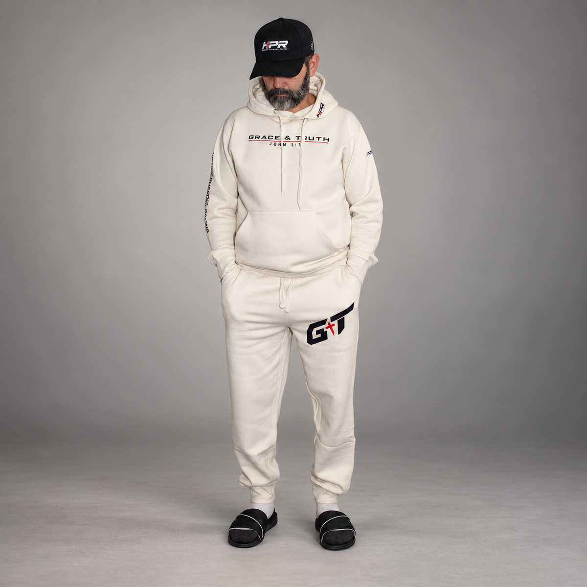 Man wearing the full Vintage Pearl Team Grace & Truth sweatsuit set in the studio