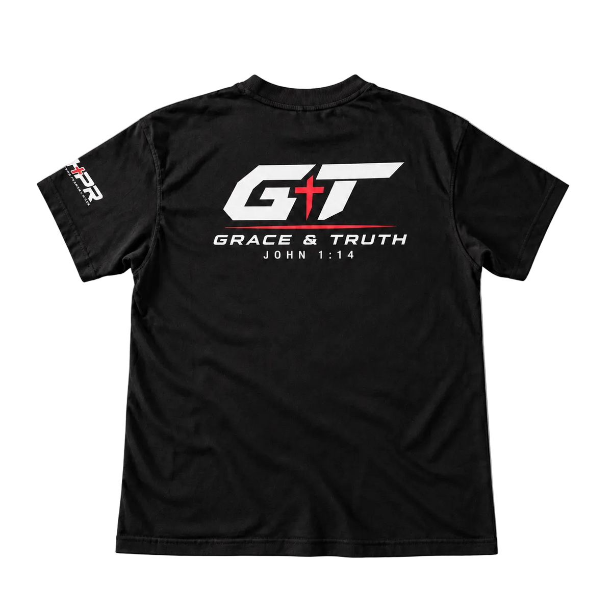 Black short-sleeve t-shirt shown from the back, featuring a large white and red 'GT' logo with 'GRACE & TRUTH' and 'JOHN 1:14' printed below, plus a small white and red logo on the left sleeve, laid flat on a light gray background.