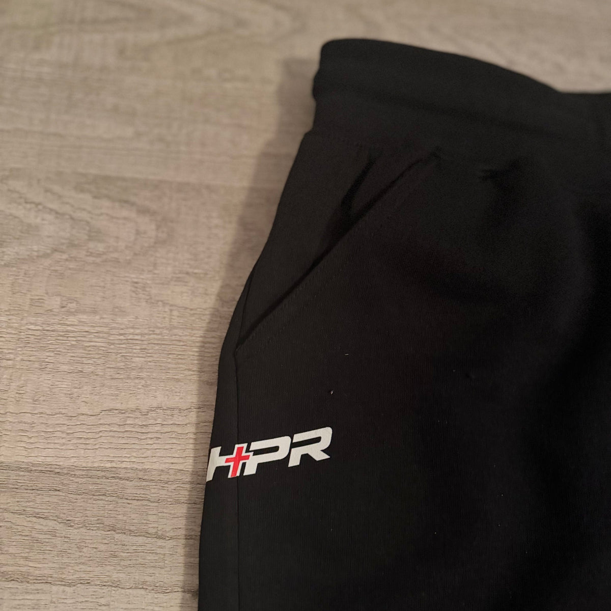 HPR logo at the hip of the black sweatpants