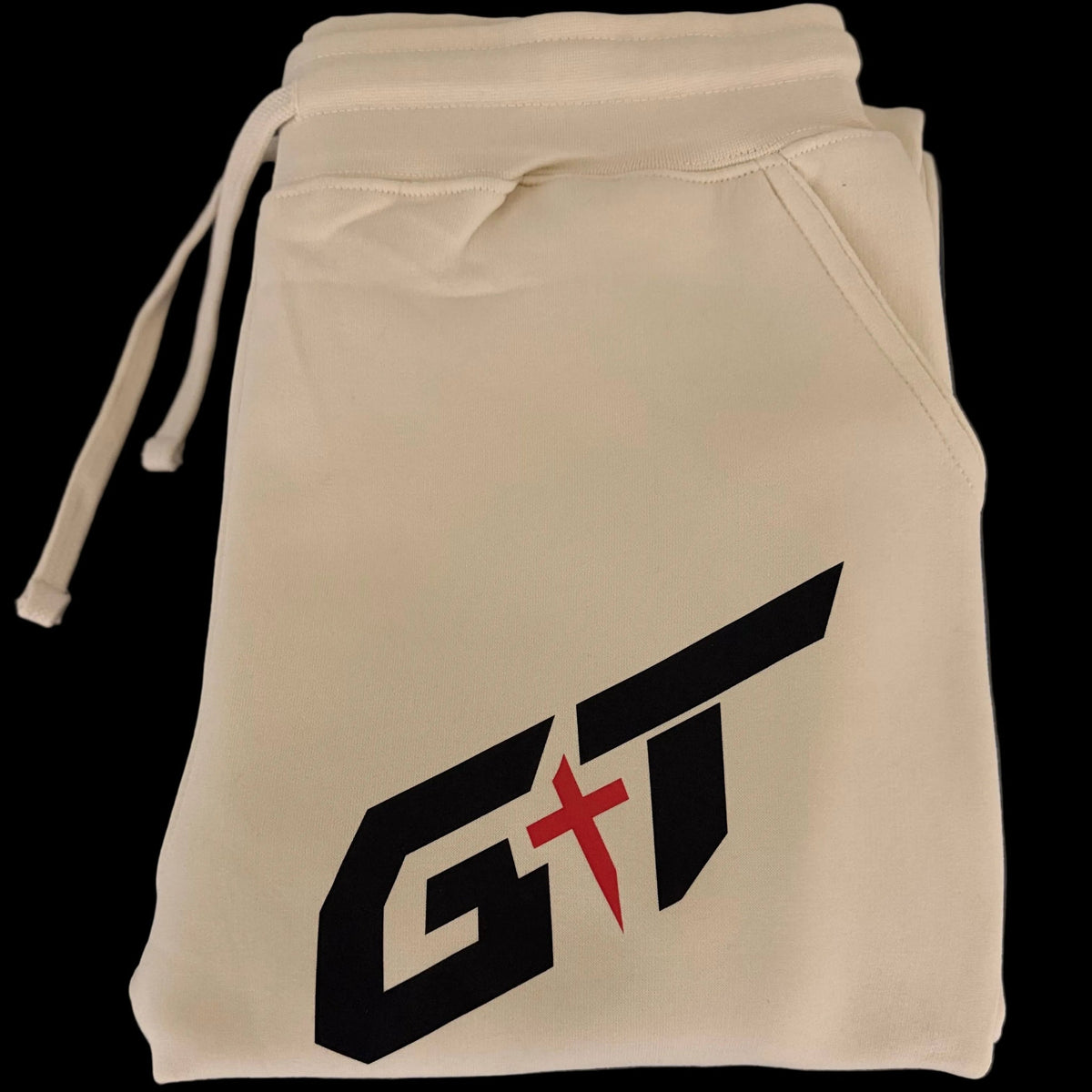 Folded Vintage Pearl sweatpants showing the black and red GT mark
