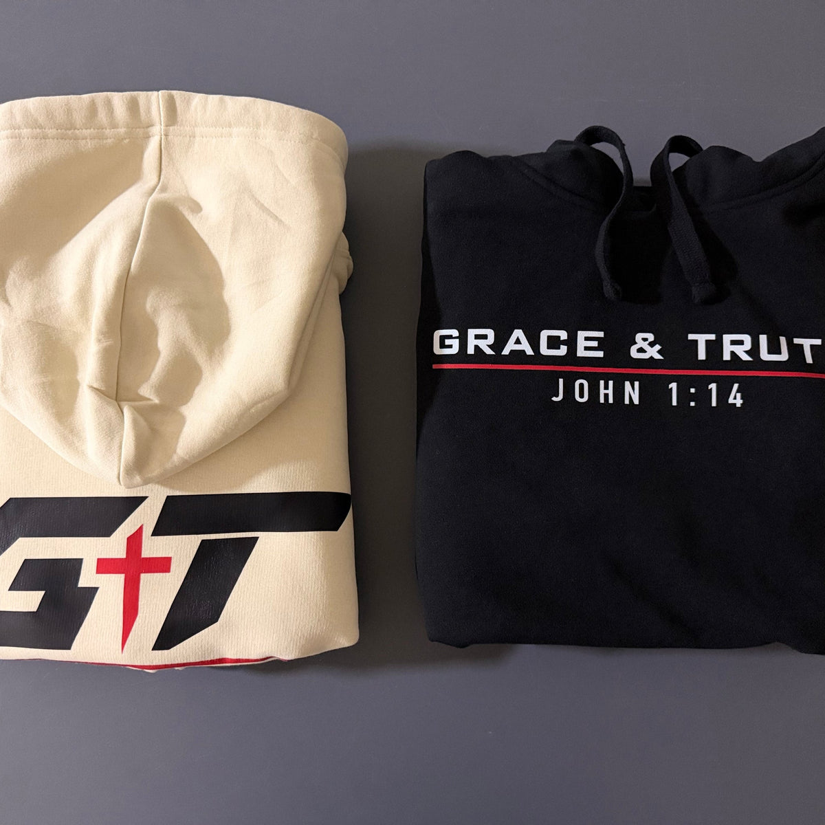 Vintage Pearl and black Team Grace & Truth hoodies folded side by side