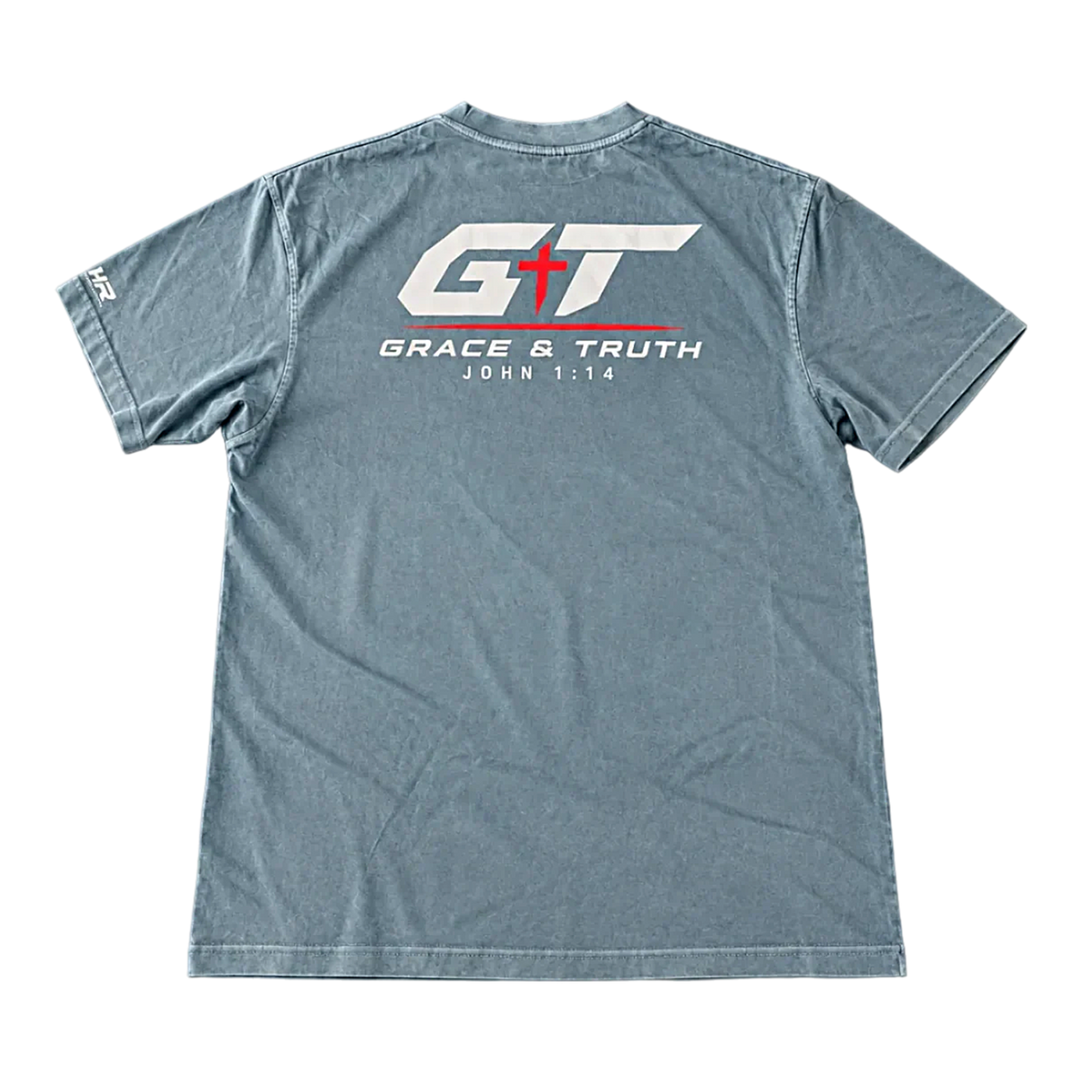 Back of the Slate Blue Team Grace & Truth Heavyweight Tee laid flat, with the white and red GT Grace & Truth John 1:14 print